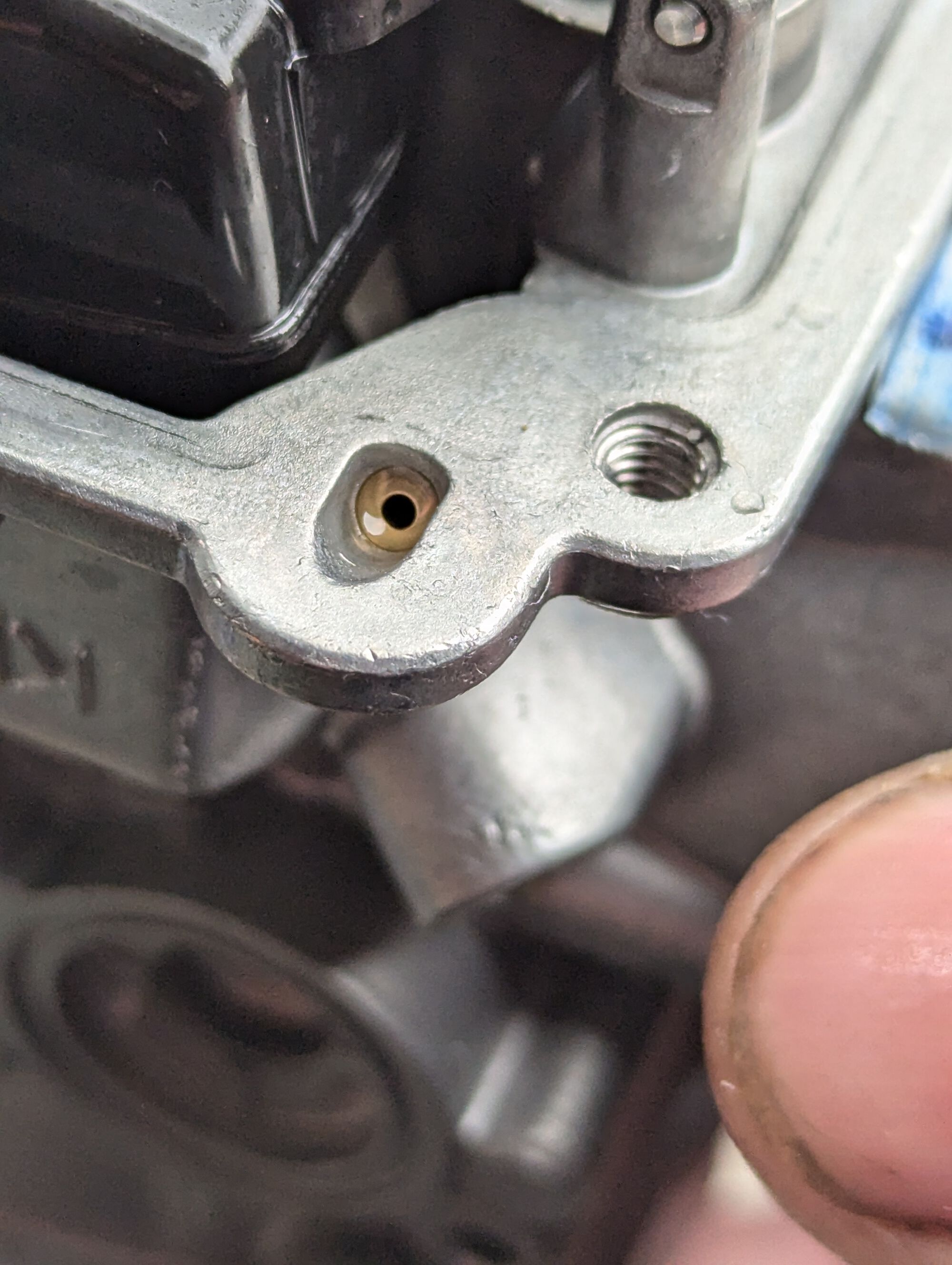 Orifice in the carburator body that feeds the accelerator pump nozzle.