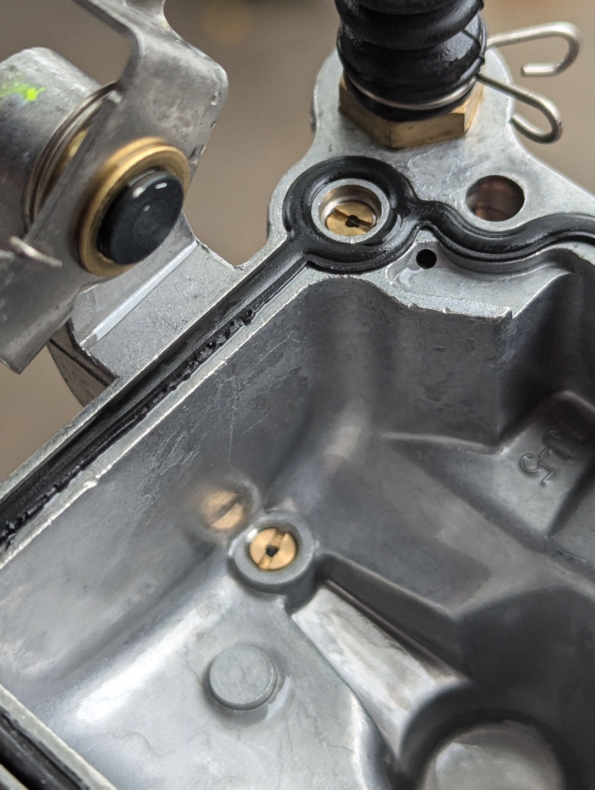 Accelerator pump feeds from the brass jet in the bottom of the bowl and shoots out of the one in the lip of the bowl. Do not attempt to unscrew these.