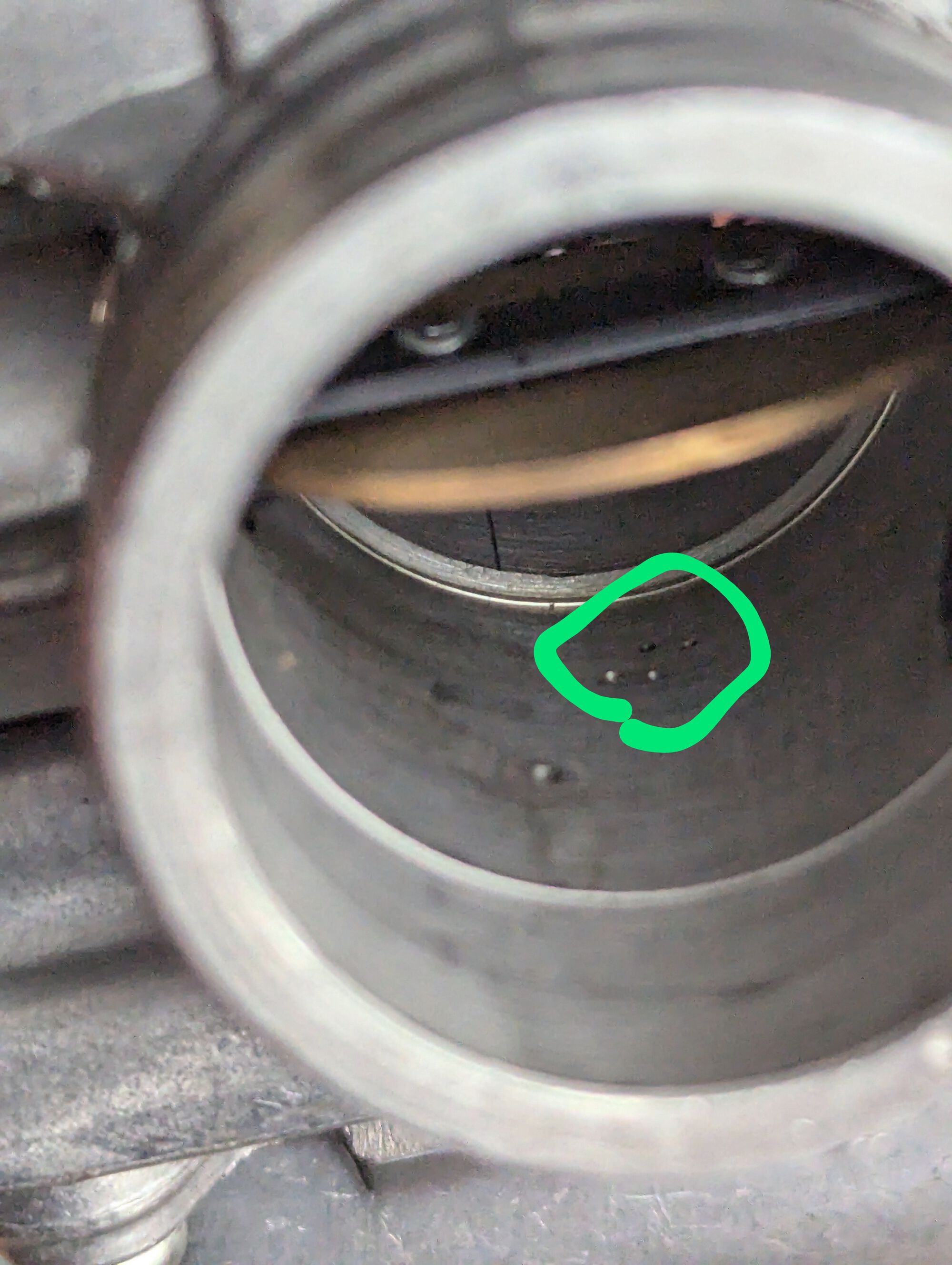 Four tiny orifices that help with low speed fuelling. Poke 'm out with a guitar string