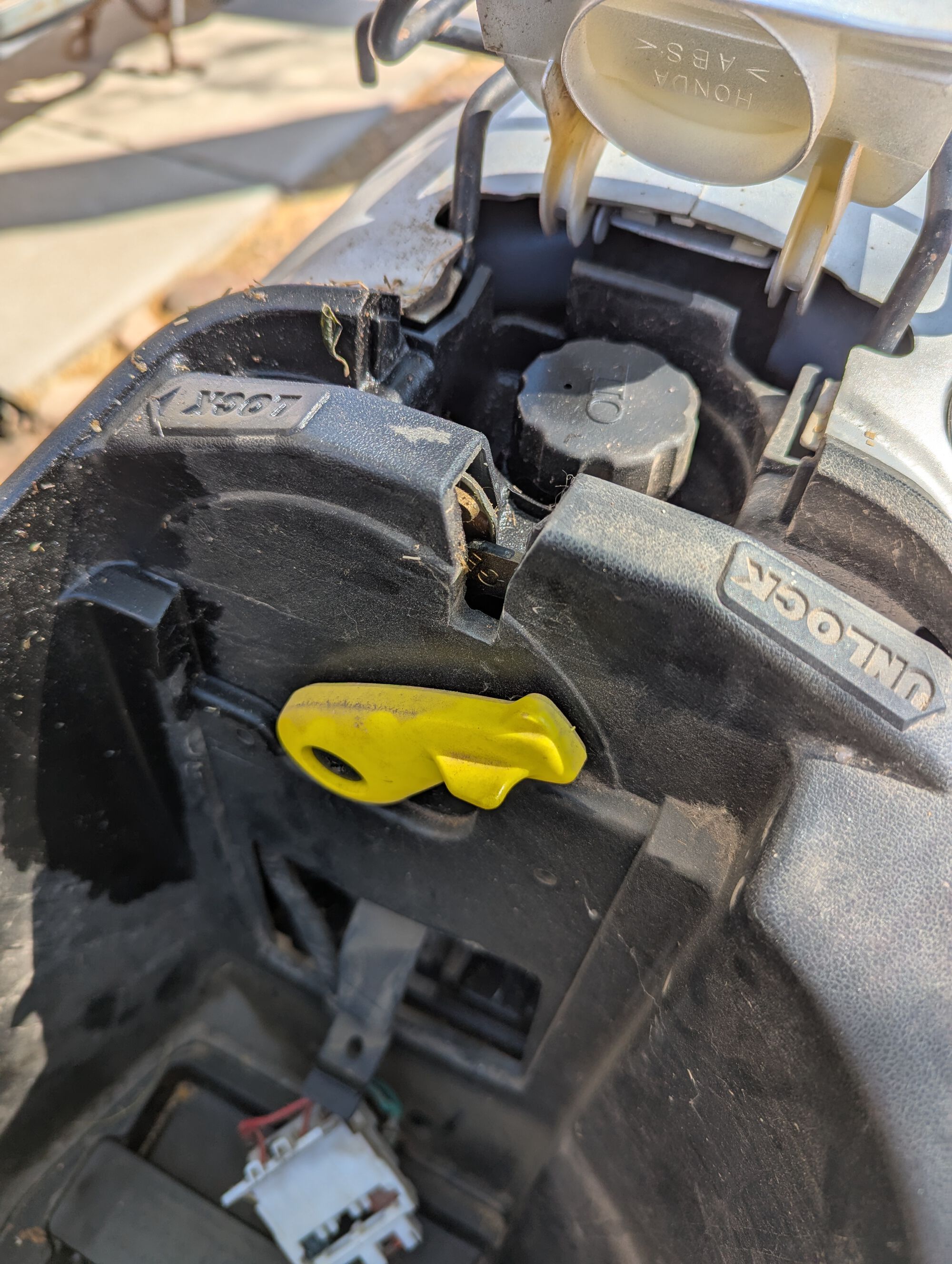 Nifty underseat feature: this lever locks the center stand on the down position, making the scoot harder for a n'er-do-well to roll it away.