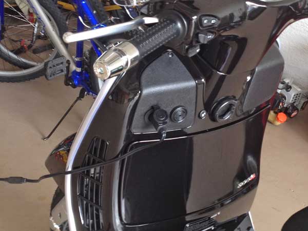 Plugging in the battery tender is now a piece of cake. No more removing the floor panel.
