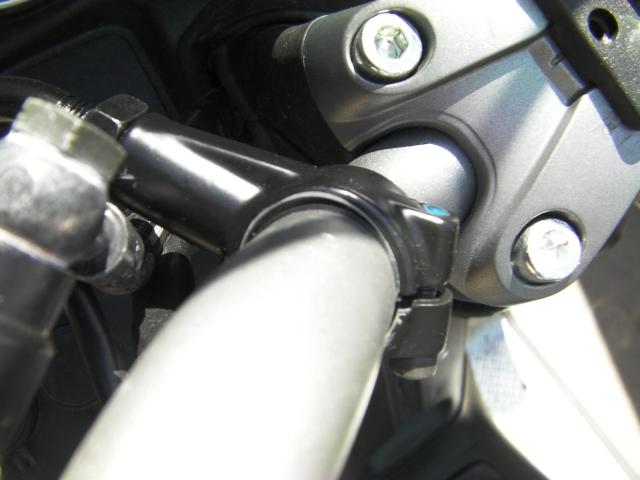 I mounted them down as low as I could on the bar so I could pull them in tight for clearance. Used some bicycle inner-tube strips for some extra grip and paint protection..