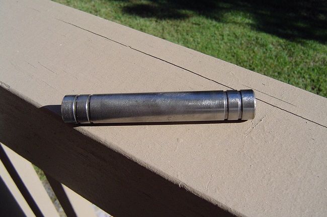 This is the clean bushing. After I lubed it up and the hole it fits into, it slid right in. I used some marine grease because I have a boat and the stand gets wet when I ride in the rain.