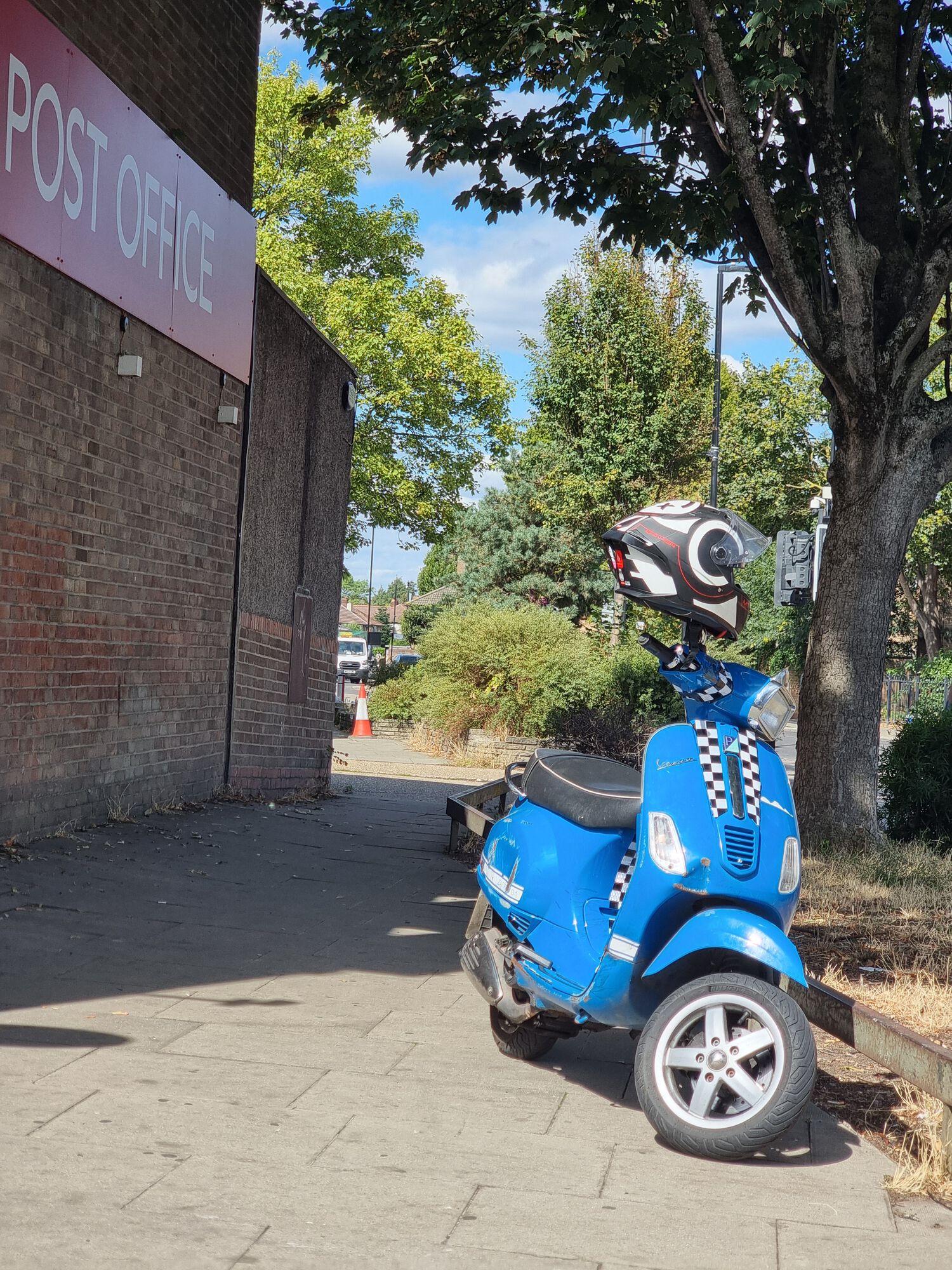 Blue Vespa S on sidestand