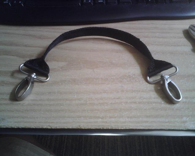 This is a strap I made from the shoulder strap that came with the bag.  It got clasps at each end and I folded over the middle and sewed it together.