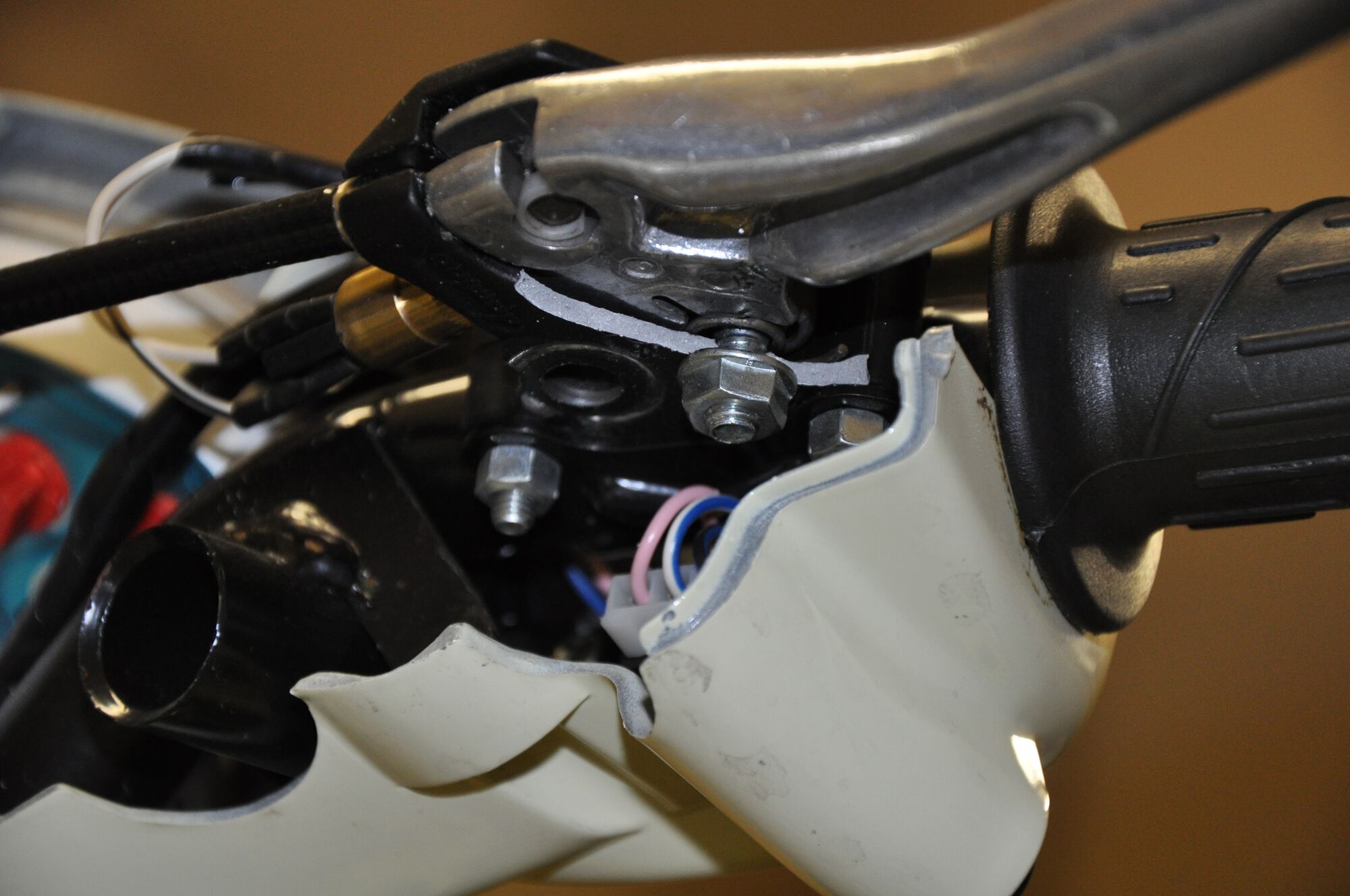 The previous owner really beat this poor scoot.  Look at the big chunk broken off of the underside of the rear brake lever perch.  I'll need to get a new on or have this one repaired if a new part is too expensive.  Also discovered the front half of