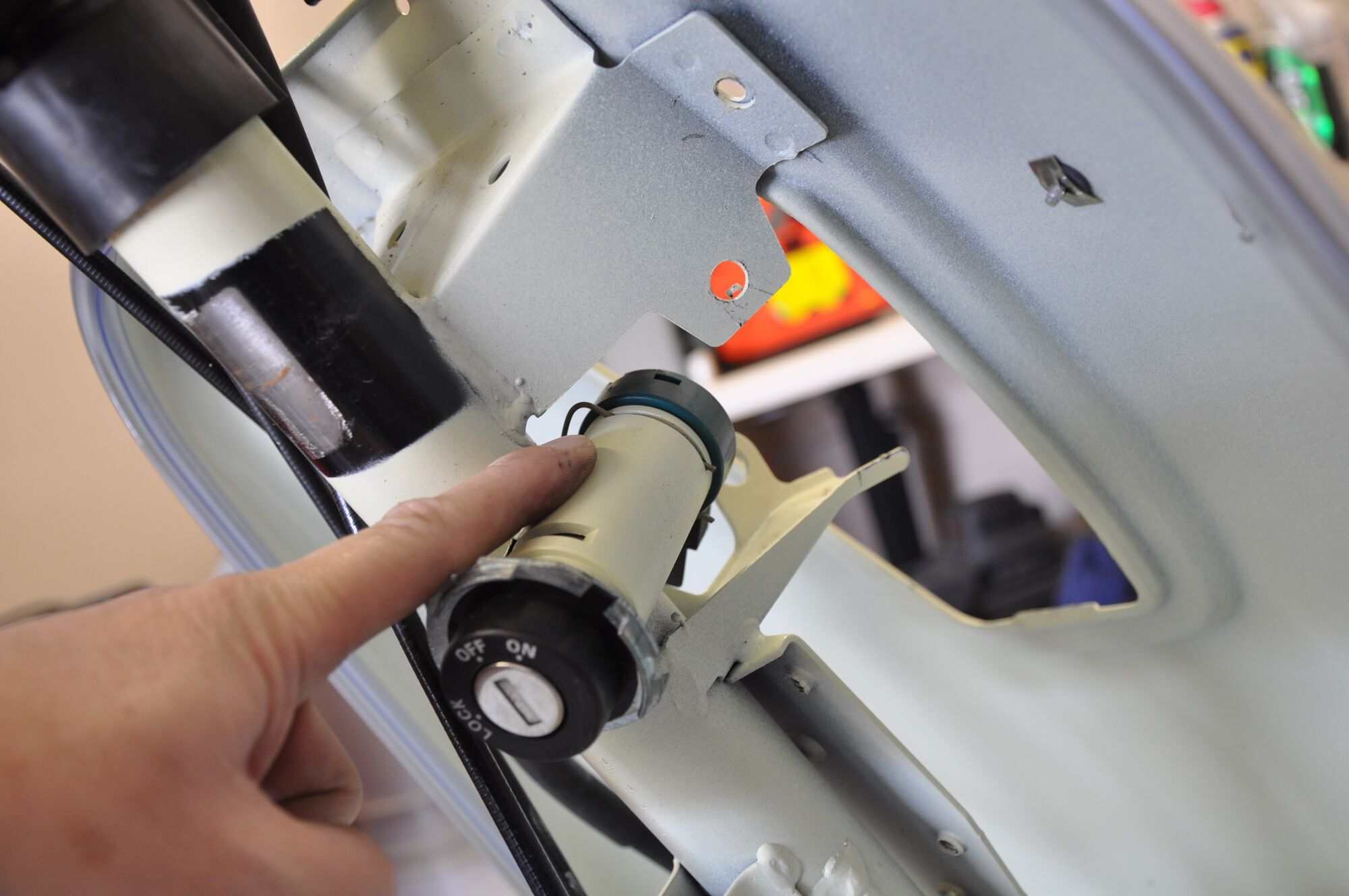 That wire clip is holding the lock cylinder together.  After removing, half the lock came out (the electrical part) but the mechanical part is still there and won't come out until I remove the fork from the frame.