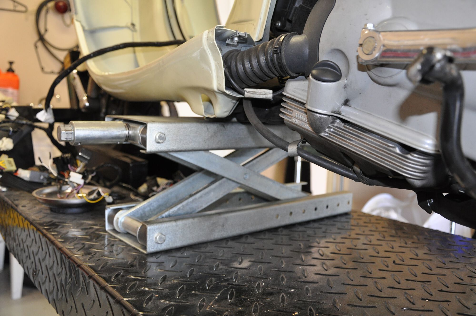 Placed a jack under the pivot bolt in preparation for removing the drive train.