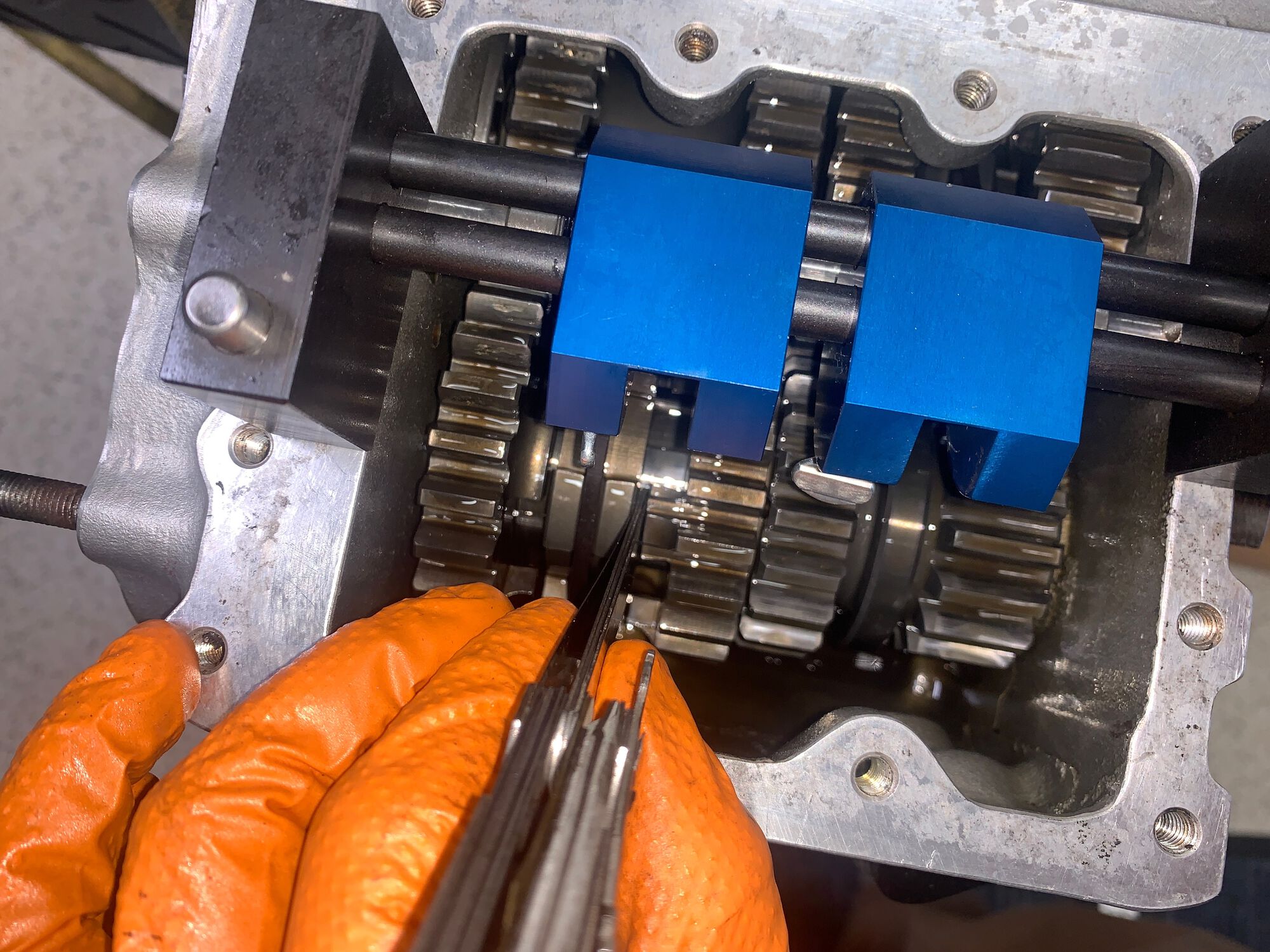 Checking the shifter fork alignment on the 1st/2nd gear shift clutch and shimming as needed.