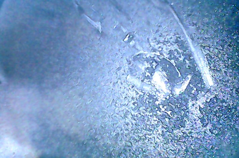 Heart of the matter.  Smear marks are where camera slipped through stuff on top of piston.  There are some particles there - tho looks like caught in time before I started excavating...  Good catch Jack!