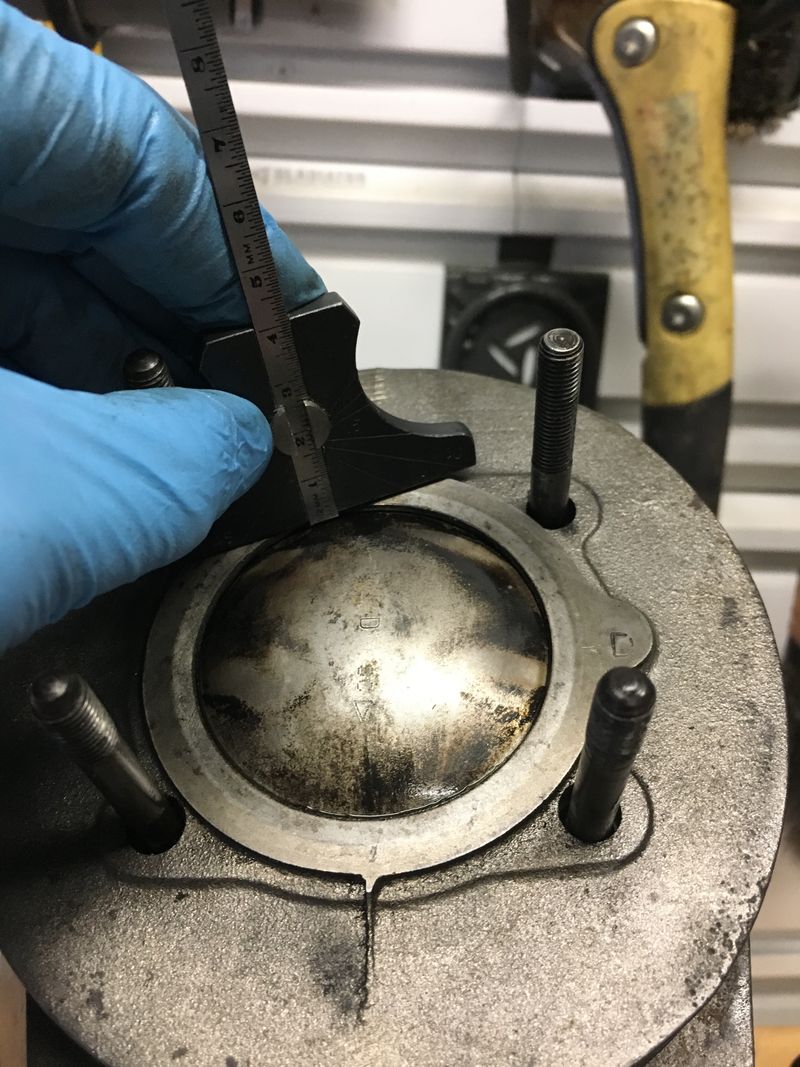 tough to measure - packer not compressed as no nuts on head bolts - but roughly .9MM - maybe as much as 1.10MM