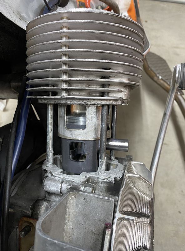Then whole thing is put on studs - slipped down half way - and flywheel is turned to bring rod end up to match.  Slide pin in from side and add last circlip.  Voila.