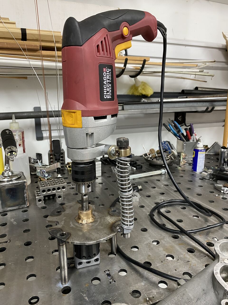 I've added a feeder so I can control the movement a bit better - spring keeps it up and threaded rod inside turns to pull it down.