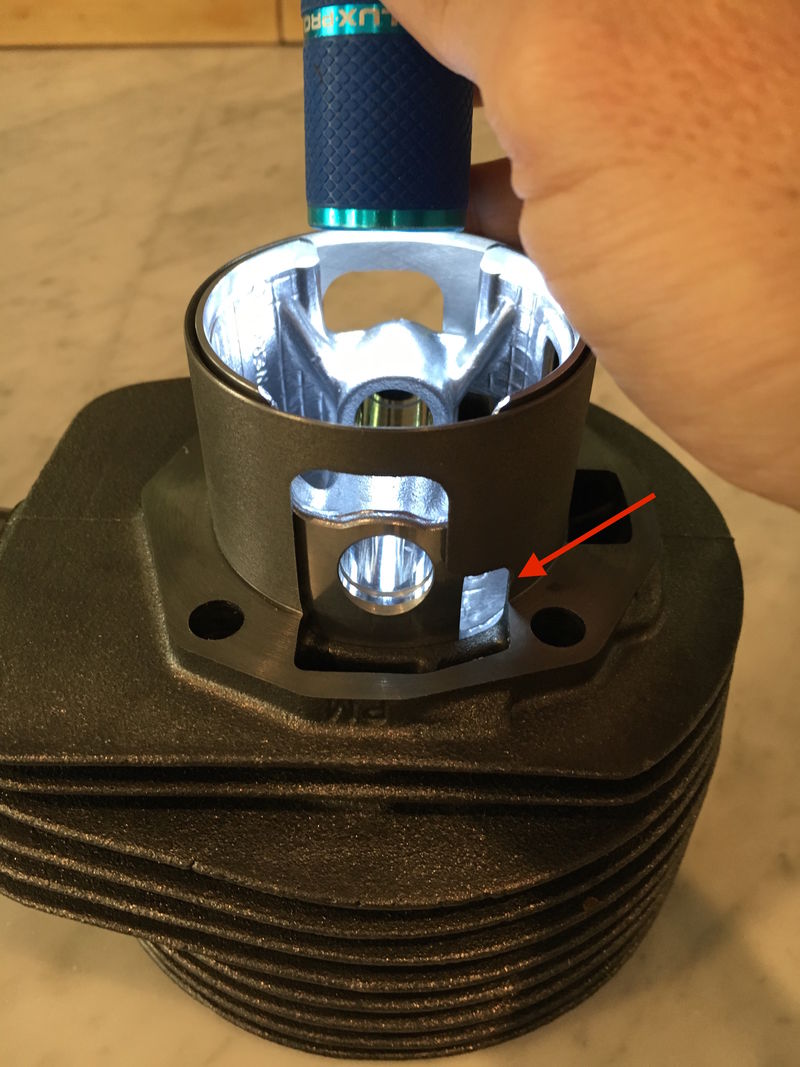 Hole in polini piston aligns with widened port - but this widened area is mostly blanked off if cases not ported.