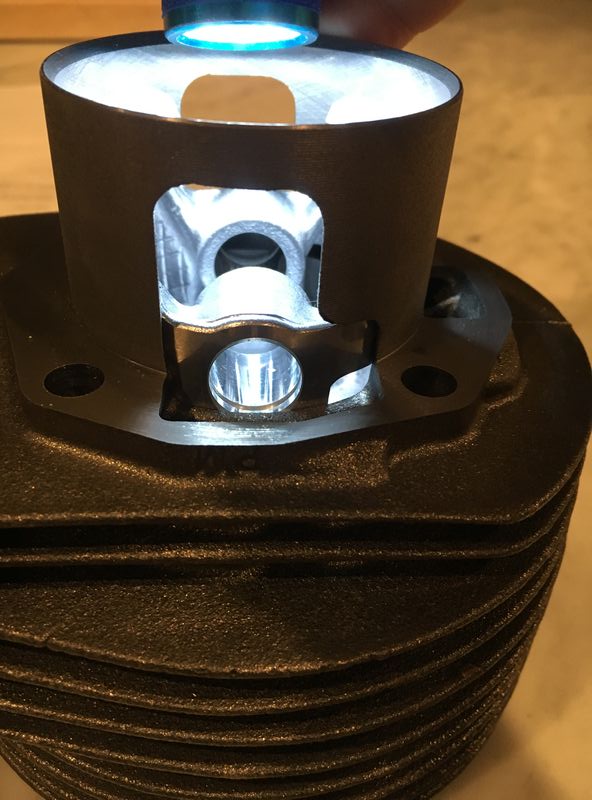 Piston is at roughly 120 here - just above top of transfer ports in cylinder.  side skirt wide open and auxiliary "polini" hole also started to open