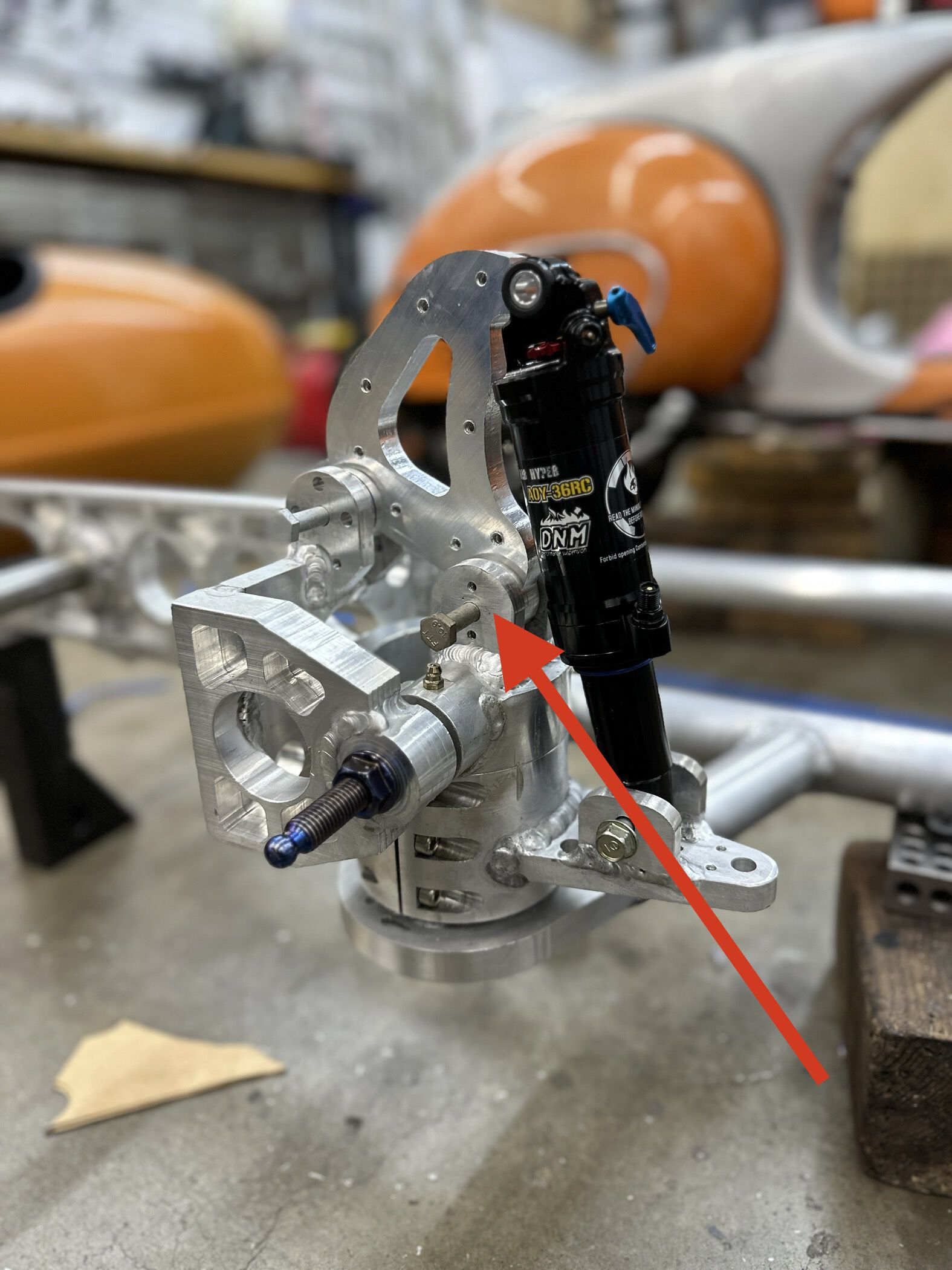 This pivot should have been on the same blue axle.  I can modify it to work nicely I think - just cut a slot in my clamp axle holder and remake the shock "hammer".  Just not this ROM...