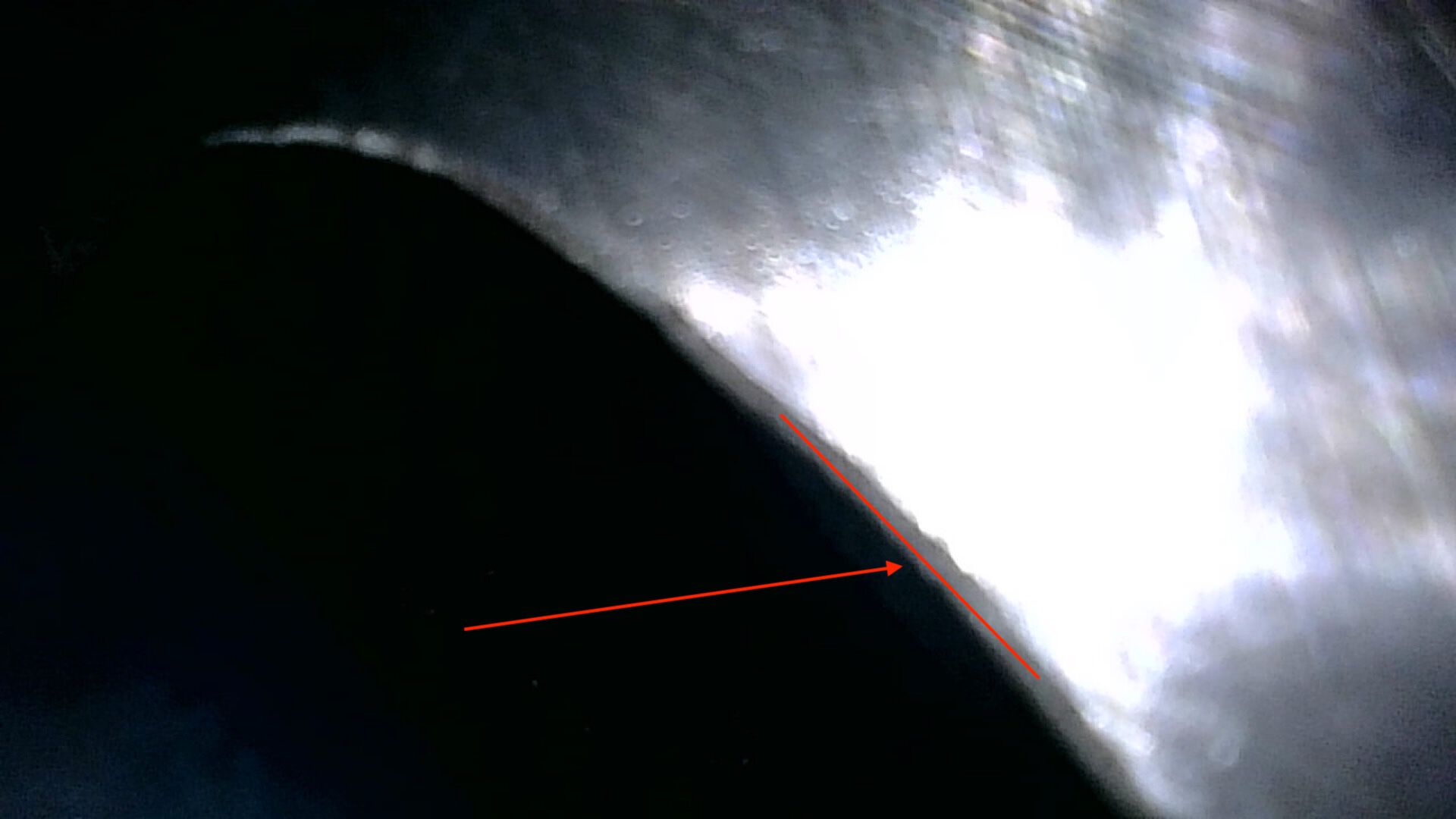 Here is a shot from the borescope when the piston is out of the way.  When I measured, I stopped with the piston reached this red line.  When I used the calipers to measure down, I tried to hit the roof ever so close to the edge of the chamfer