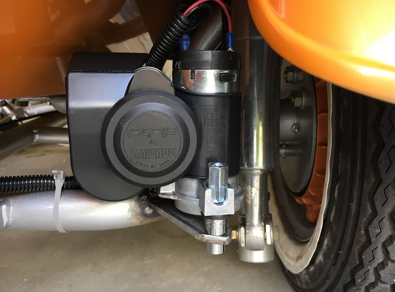Welded the tab on to frame under sidecar fender.  Came out a bit more refined than bat. box...  used small rubber grommet to insulate from shock.