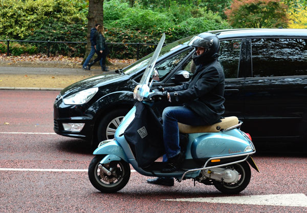 A slightly beat up Vespa near Hyde Park in London.