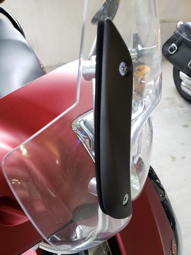 Possible solution area...raise up the windshield on its support rods to move headlight farther down from windshield...HAVE NOT TRIED THAT YET