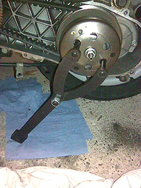Undoing the Clutch Bell nut. Note that the drive belt case still has no belt dust evident - so I guess that I've cured that problem.