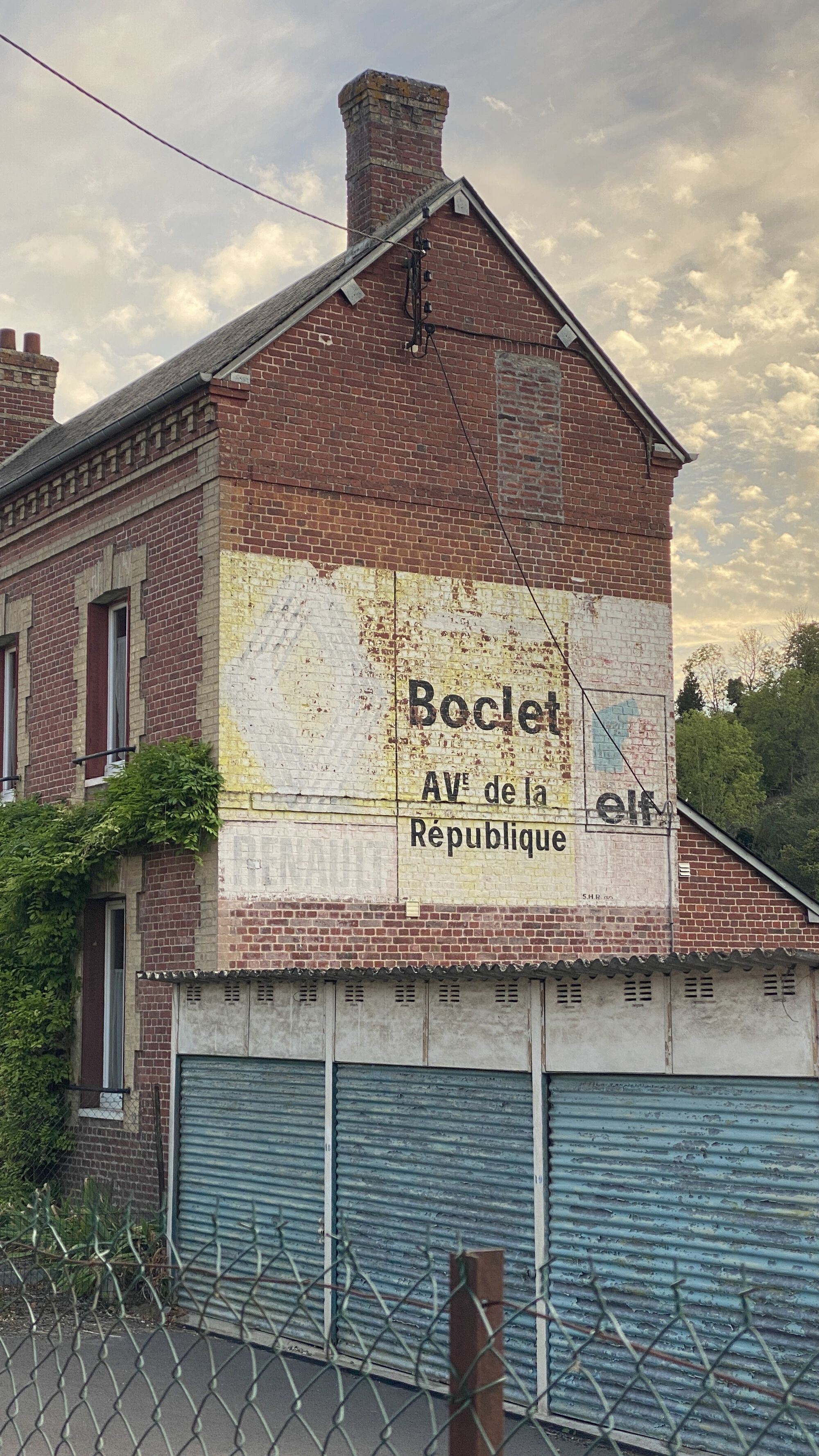 Relics of roadside advertising painted straight onto buildings: the Renault logo hasn't been used for a few decades