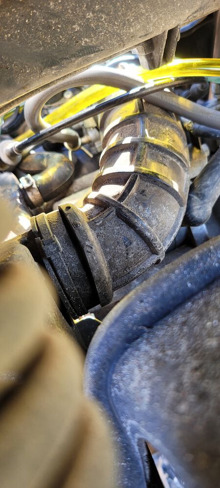 Back side of air intake tube, not sure if its visible from the pic I could get without taking the body off, but there is a separation near the airbox connecting side about an inch and a half long and maybe 1-2mm wide