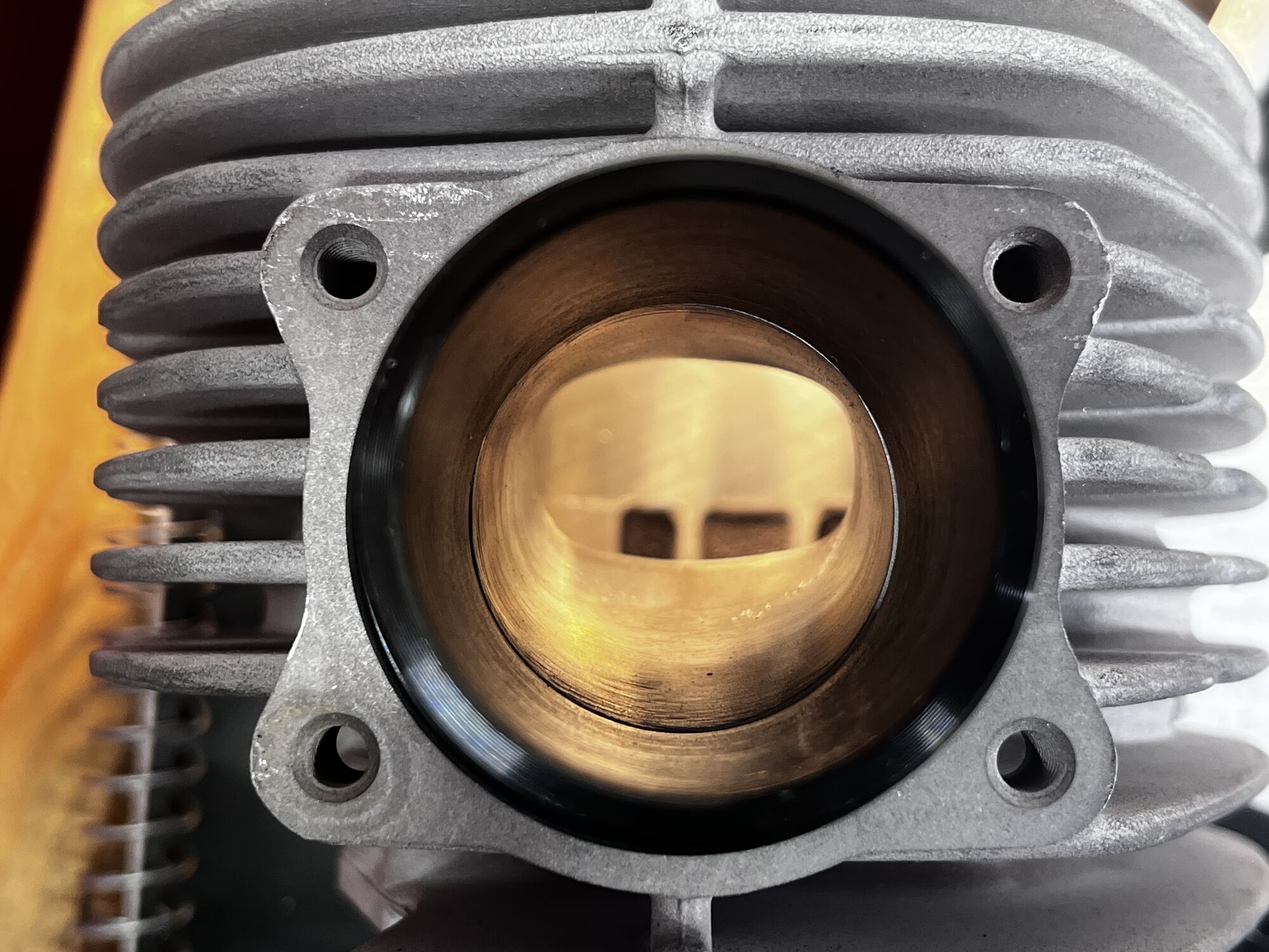 Exhaust outlet with manifold. The outlet on the cylinder was originally 1mm narrower diameter all around. Now nice and flowed!