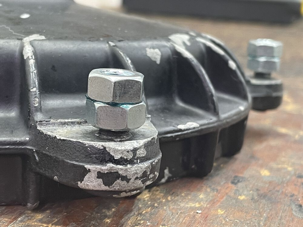 just enough room to back them out, then grind off the back swedged portion; before removal of the stud