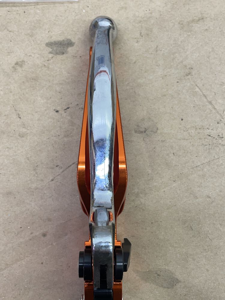 Showing comparision of an original Vespa lever (in chrome), and the new Alum lever. The Height (the part where you grab & pull) is about 80% taller than the original. Seems like it will be very comfortable.
