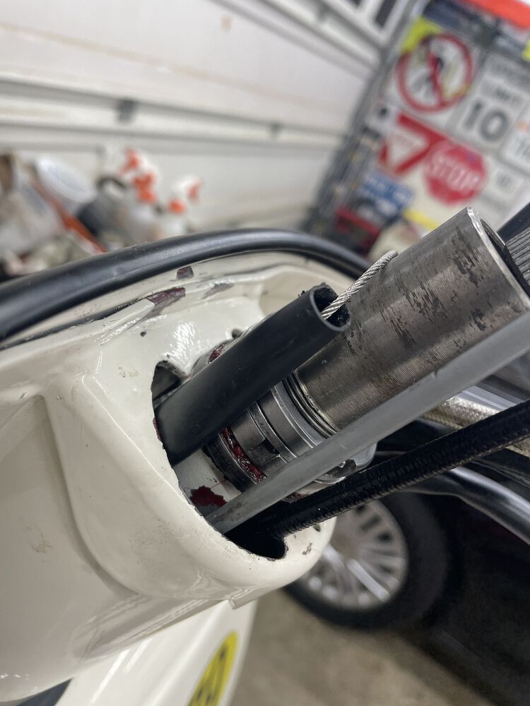 I'm trying an experiment. I ran the sheathing for the shift cables all the way from engine compartment to the headset. It made running the second cable very easy, and I think add's a little protection for the cables.