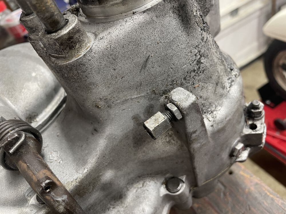 this adjuster must be removed, and the hole in engine case bored out slightly to fit the new cable outer end.