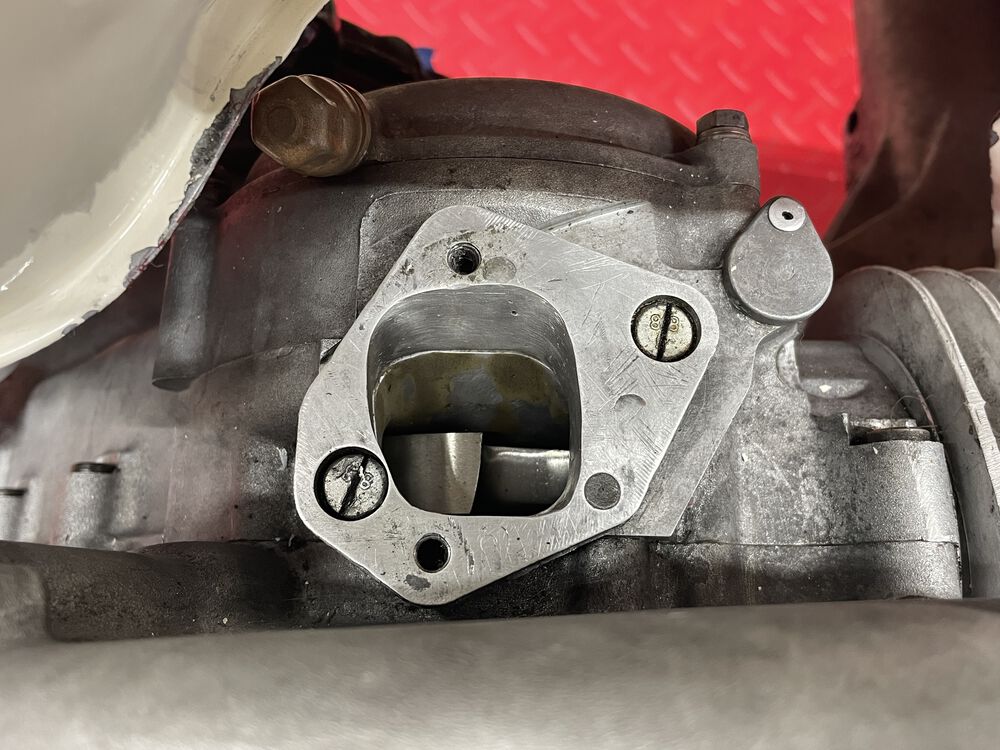 the adaptor plate.  Opened up just a bit....  There is alum material added to the clutch side before porting. Obv's it's seen some rough days. I resurfaced both faces after this photo.