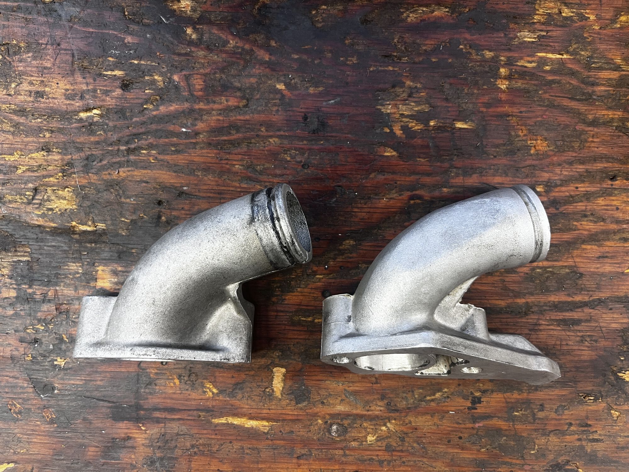 Polini on left, Malossi on right. Both situate the carb at about the same angle and height