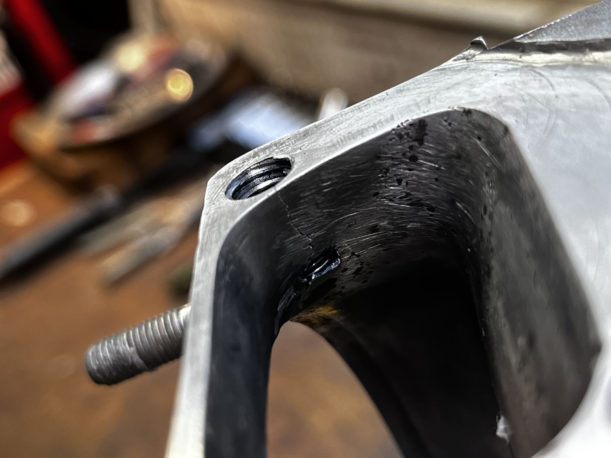 Cracked case, rear intake bolt hole, and open void at bottom of crack.