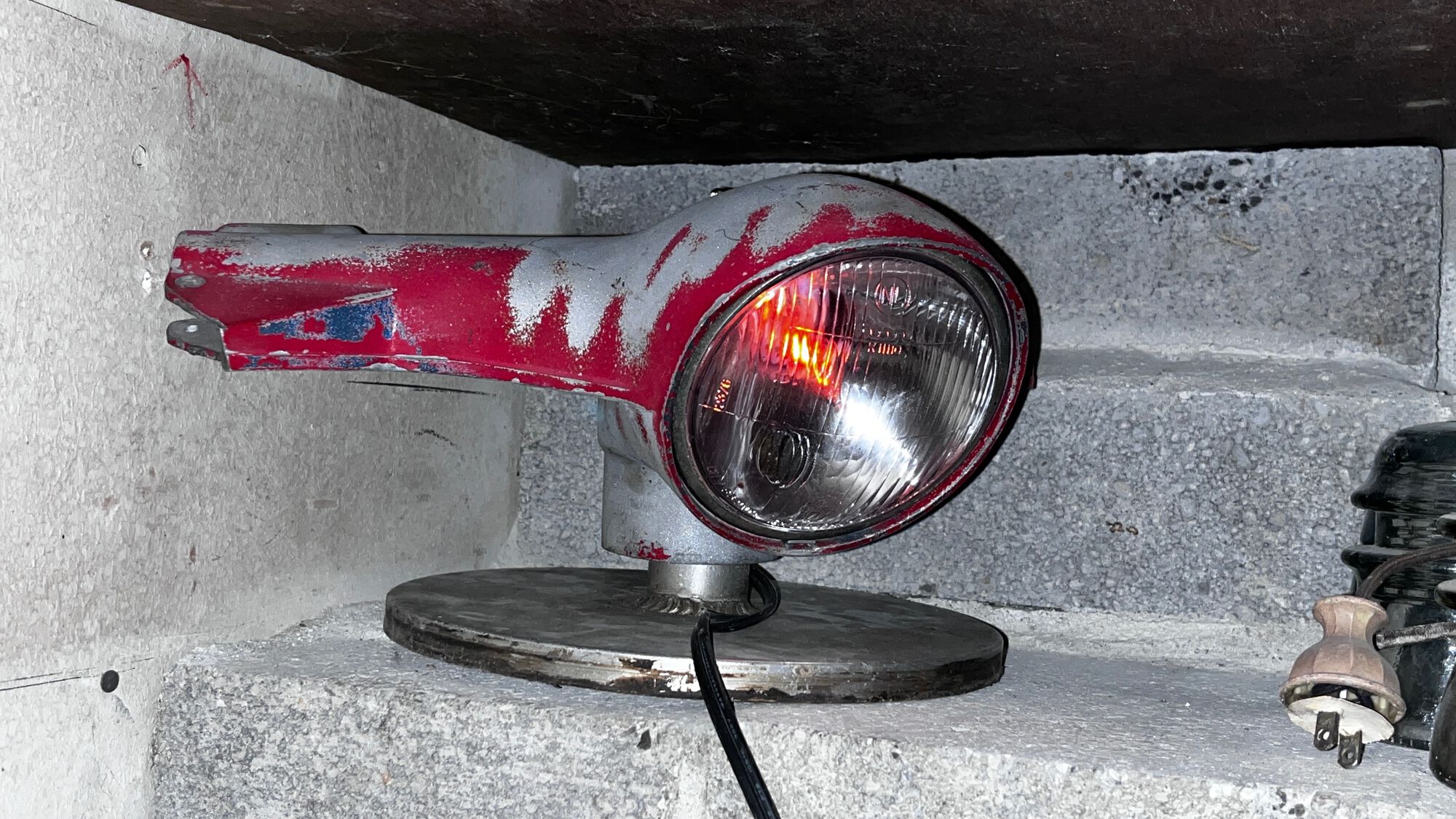 Janky old 90 smallframe headset + old disk sanding plate + electrical junk = cool Vespa accent light! The bulb is a candle base 'flicker' bulb!