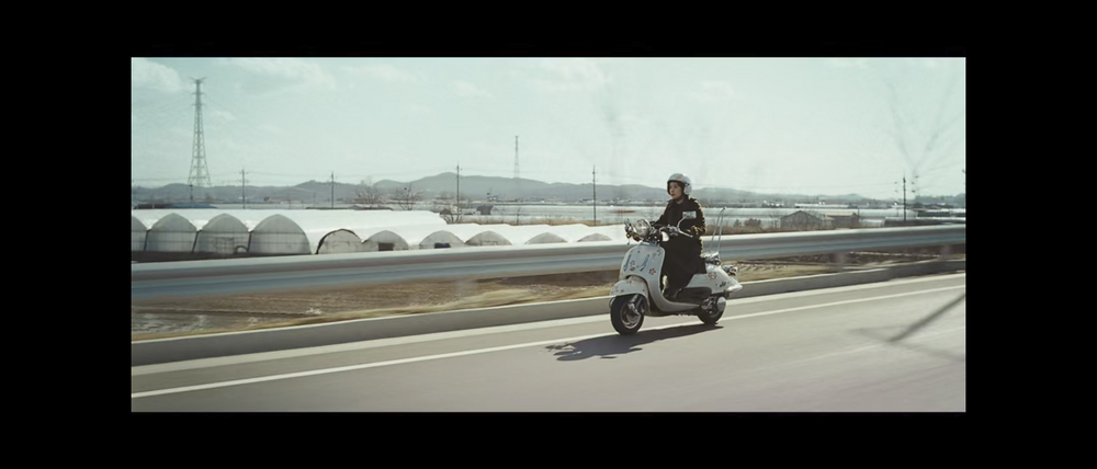 One of the main characters, Eun-yi, played by Jeon Do-yeon rides a scooter in The Housemaid (2010).