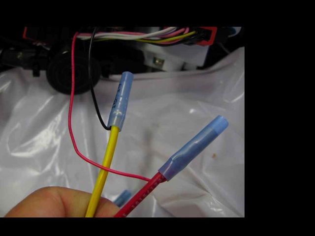 I joined 18 gauge wire to the ultra thin wires from the buzzer by using a butt connector.  I didn't have butt connectors small enough for the wires on the buzzer, so I used a one sided butt connection by using a 14-16 gauge connector to join the the 18 ga