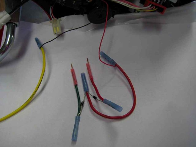 Here's the entire set of connections.  Using a 14-16 gauge butt connector, I crimped both diodes onto the 18 gauge wire coming from hot side of the buzzer.  Then each "plug" wire for the connector was crimped onto an individual diode.  I later w