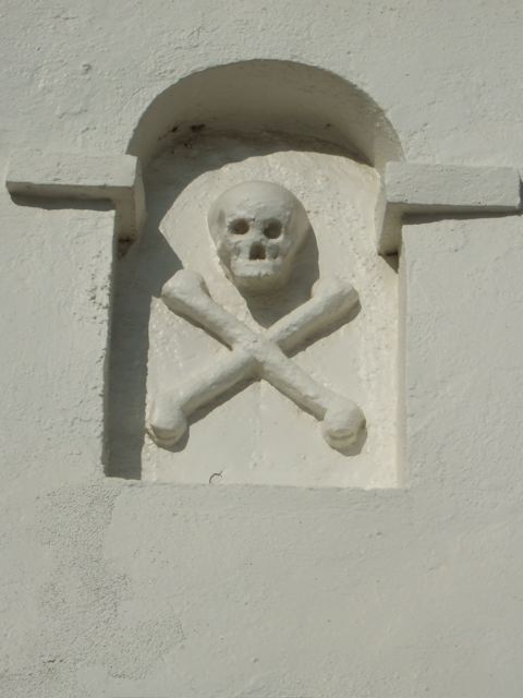 Above the entrance to the Mission's cemetary. (reminds me of the Pirate's of the Caribbean attraction at the happiest place on earth...)