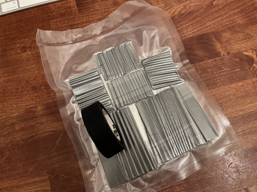 I got this nice 3m fabric electrical tape from watching a youtube video about making harnesses. It doesn't turn to slime. 

I think I'll add like a short bit of heat shrink to the ends of the tubes, but other harnesses I see don't have those.
