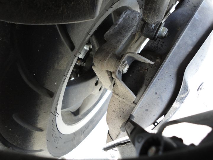 So I took a picture through that hole of the nut that needs to be removed to get the side plastic off - well the spanner is on it to show where it is.