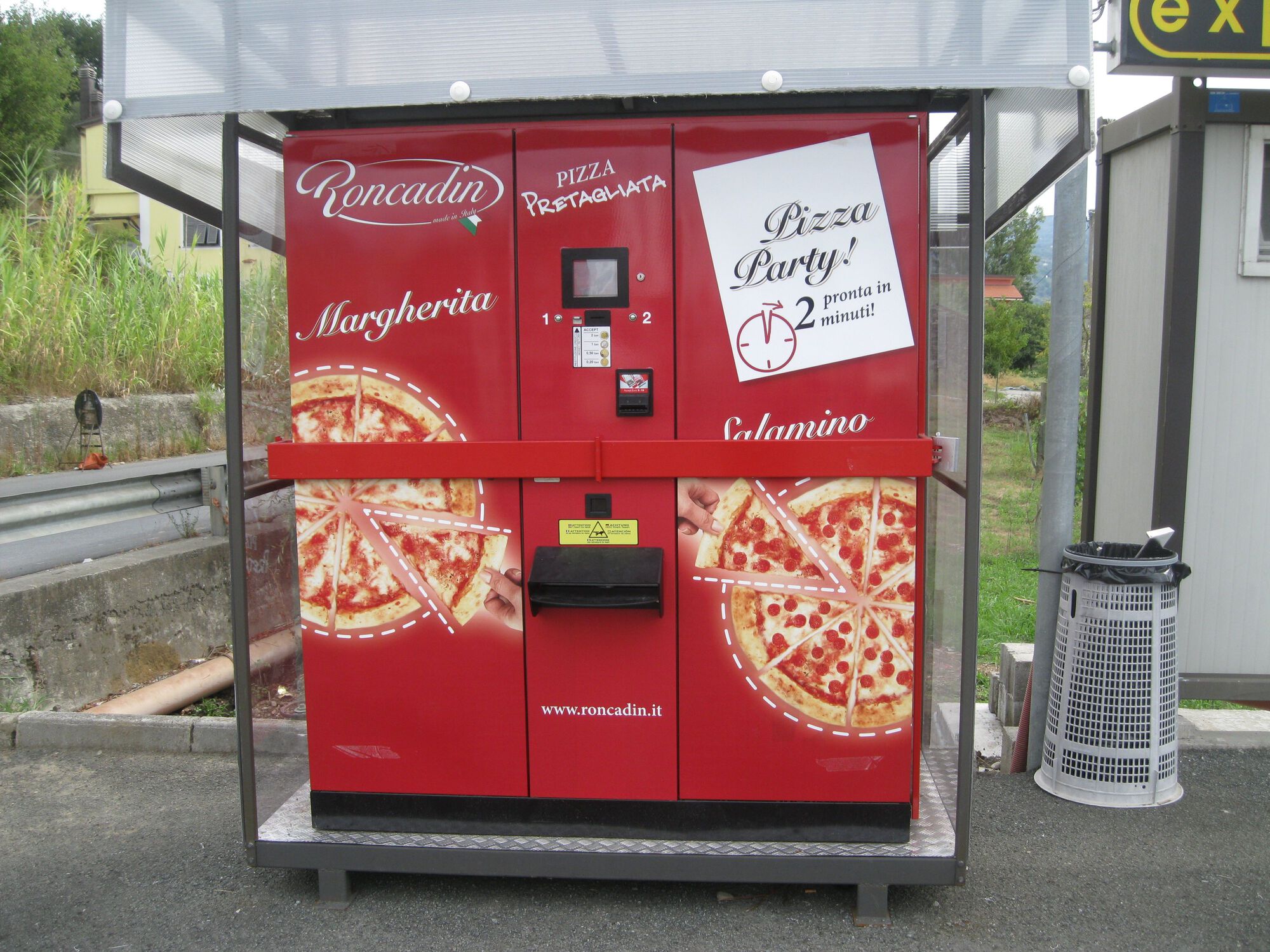 A coin-operated pizza machine at a gas station just above Monaco