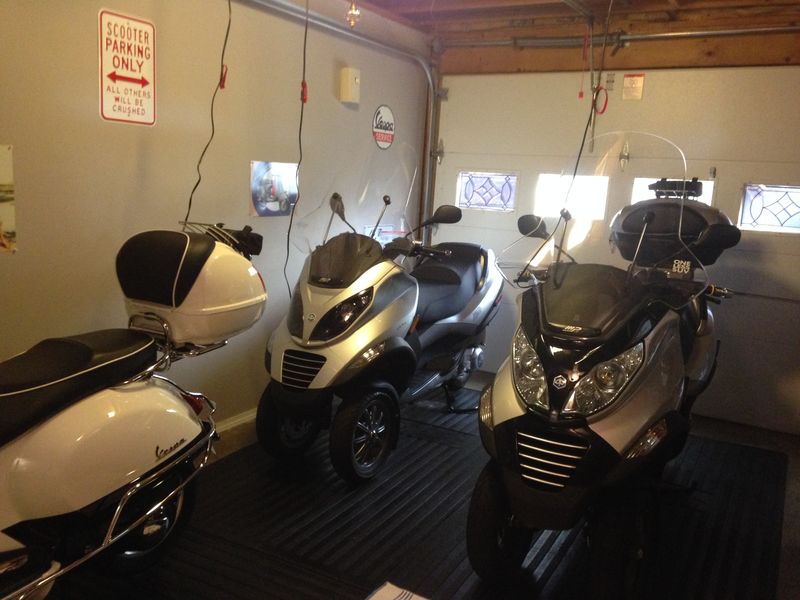 Keith's Garage... On the Left: 2012 GTS/Super, New 2009 MP3/250 Parked behind.  On the Right: Old 2009 MP3/250 with 11,000 miles.  Both bikes now have Maksor Modified Chrome Headlights w/Blue Tint, with H4 Bulbs.