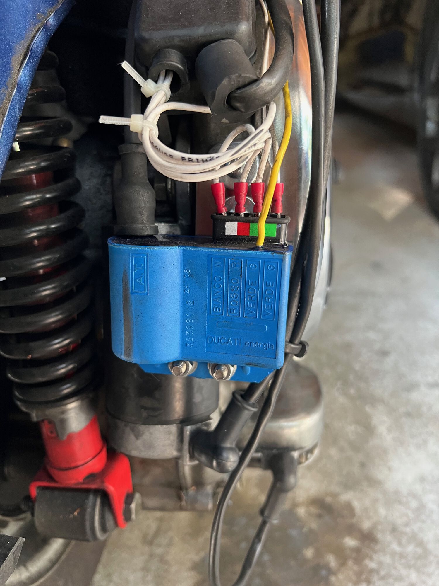 One of those nifty CDI boots is on the way. Might color code wires some day, might not. Black marks are from thick sound insulation used inside right cowl on Stellas.