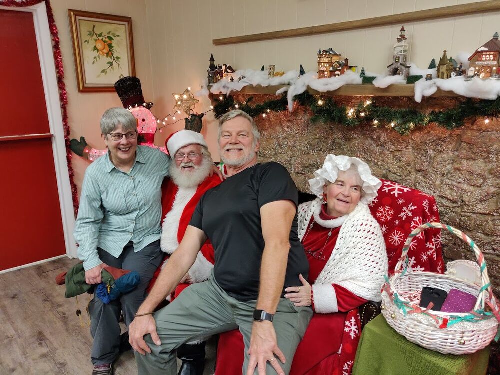 Susan and Warren telling Santa their Christmas whishes. If we had just known. (I think Mrs. Santa just wants relief.)