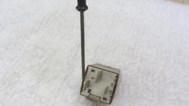if you wish to try and clean the relay gently pry it open