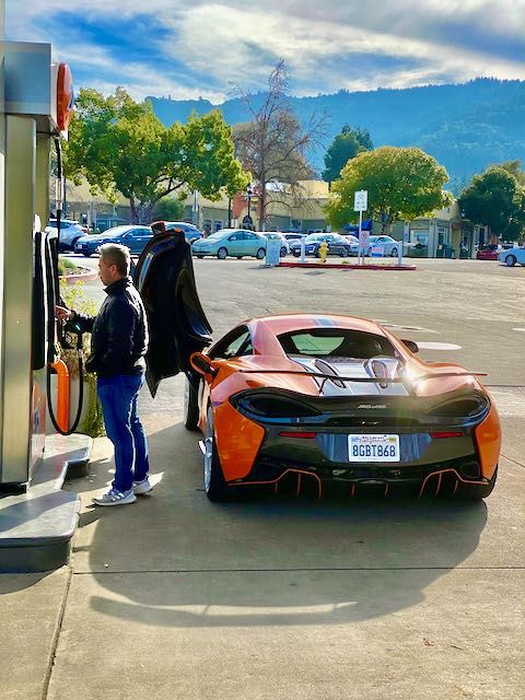 McClaren. The door opens up and out so you can step down into it.