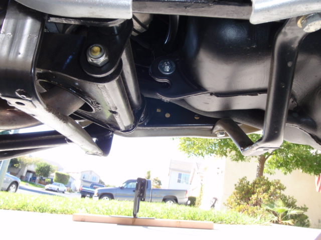 Plastic skid plate removed to show mounting location of plate.