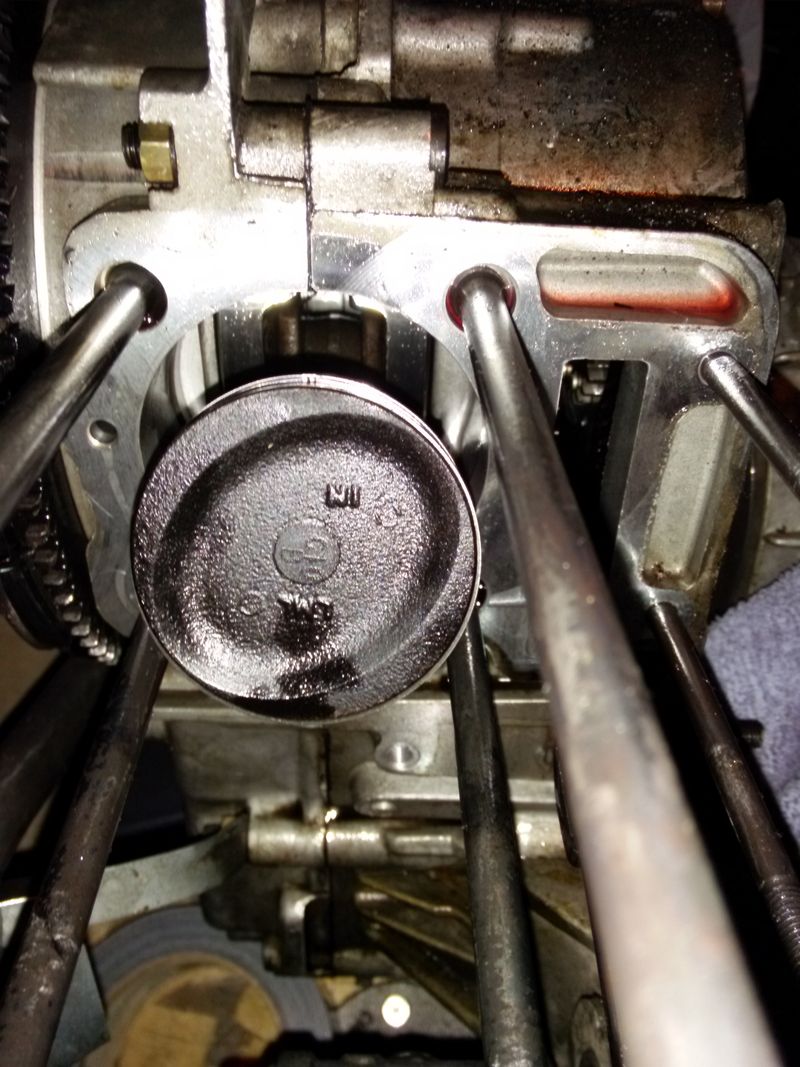 Is that carbon on the piston top or some kind of coating? I let some MMO soak in and scrubbed it with a brush, some carbon came off but it's still pretty black